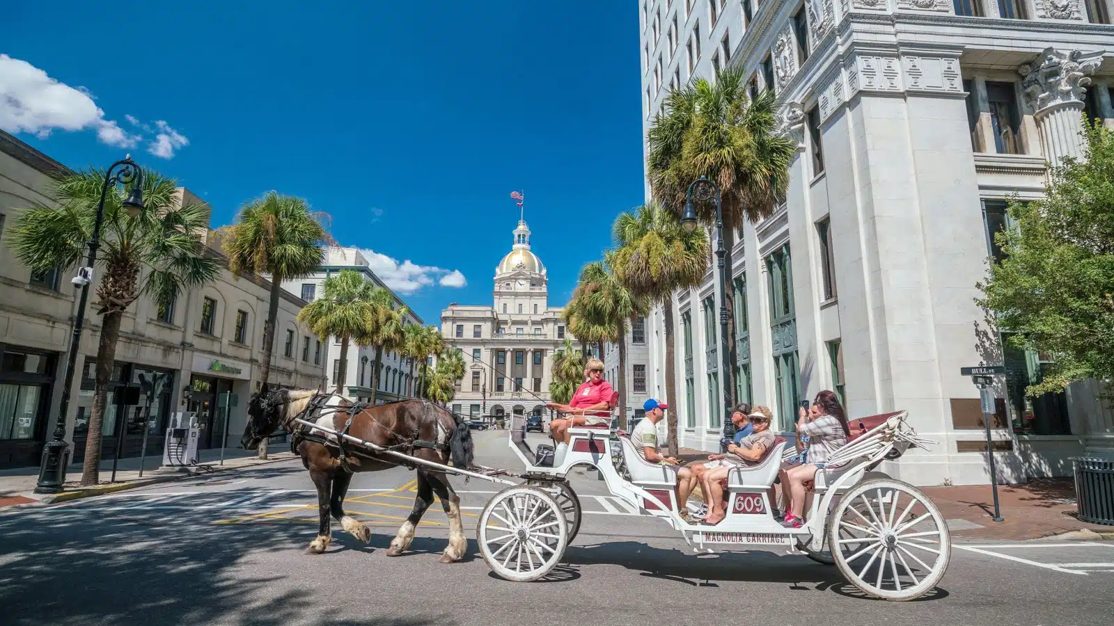 Tourists taking a horse & carriage ride through downtown Savannah.
