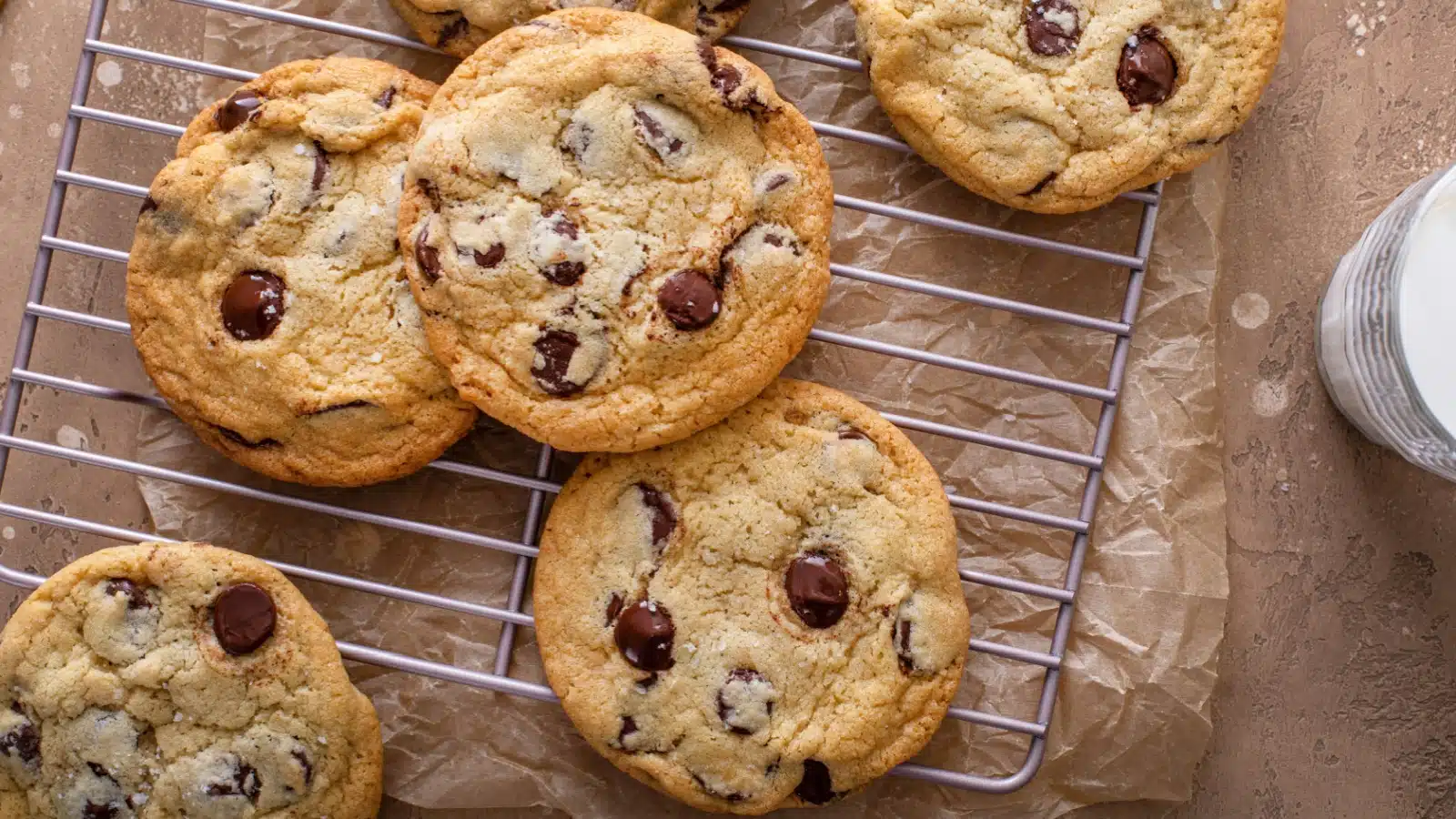 Chocolate chip cookies cooling on a rack.