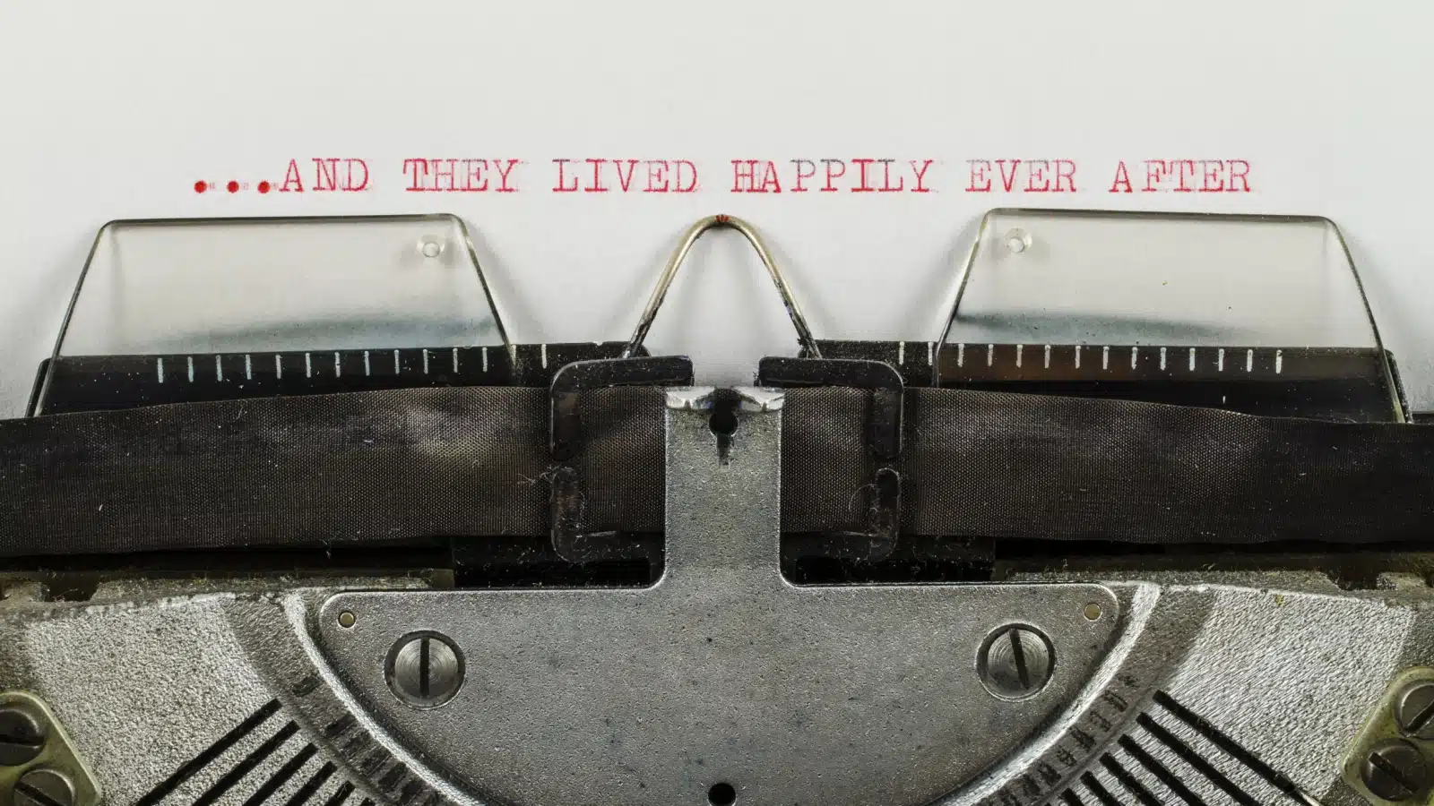 A typewriter with the words "and they lived happily ever after" typed on paper. 