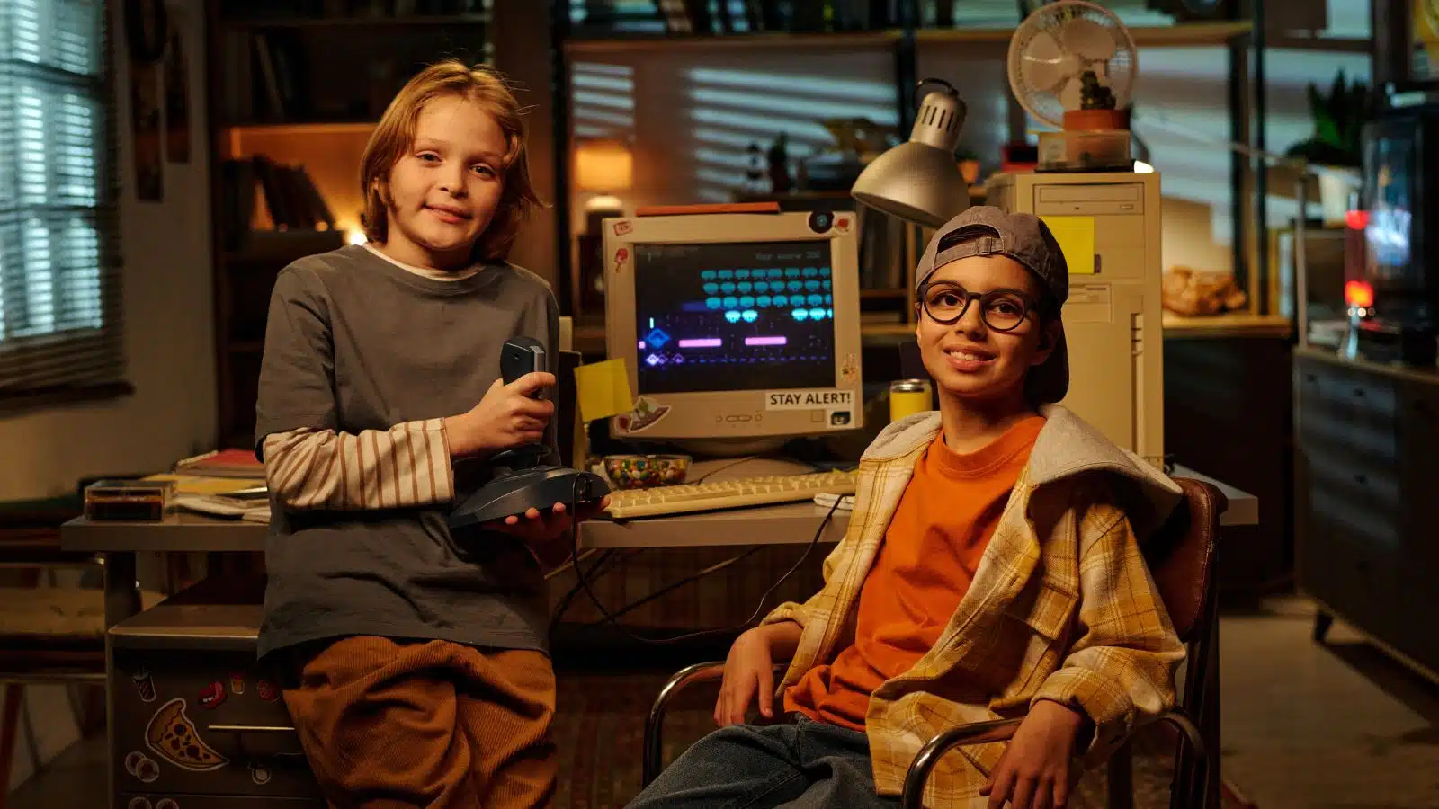 90s kids play a video game on an old PC in the early 1990s.