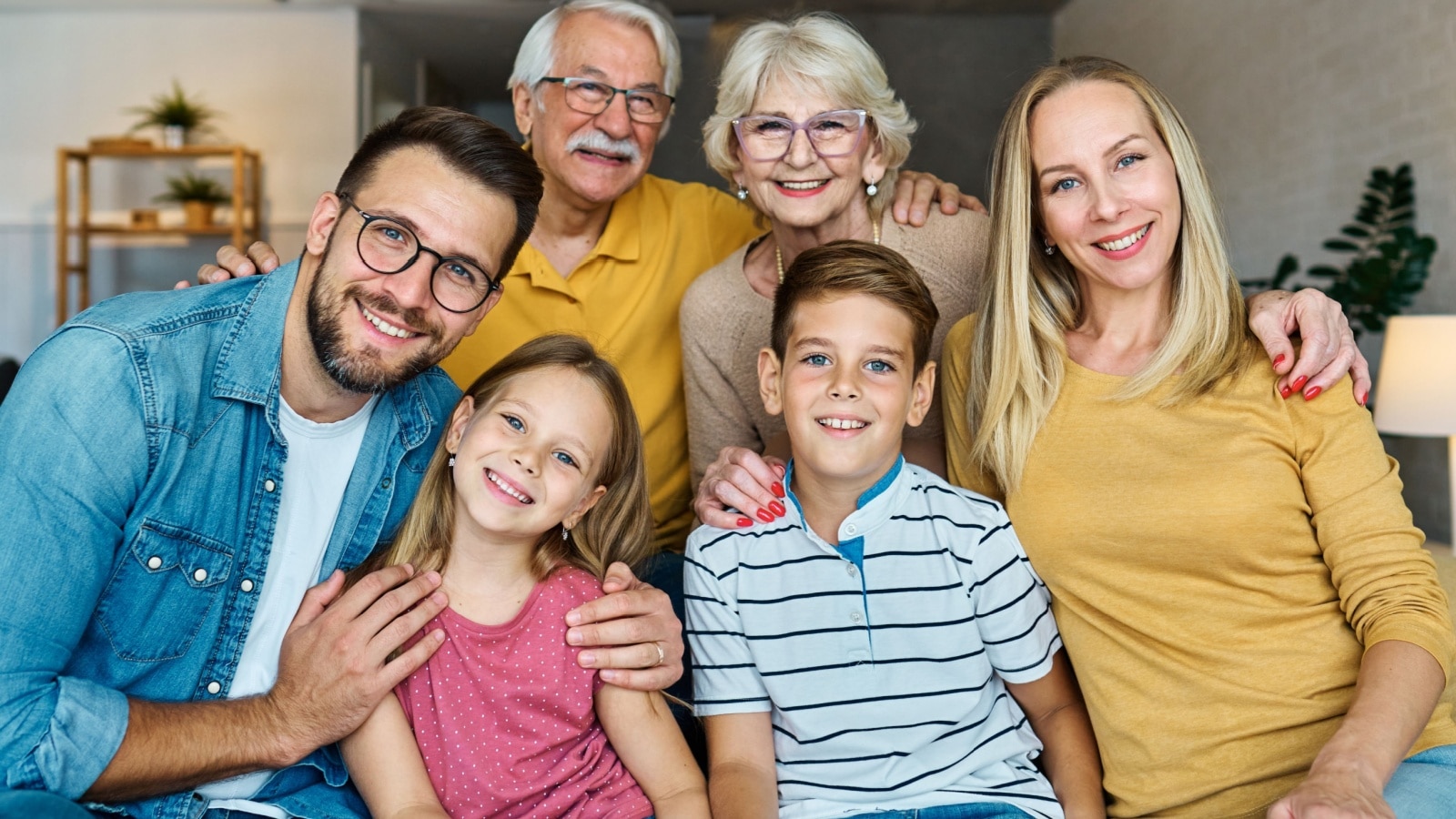 A family photo featuring three generations, parents, children, and grandparents.