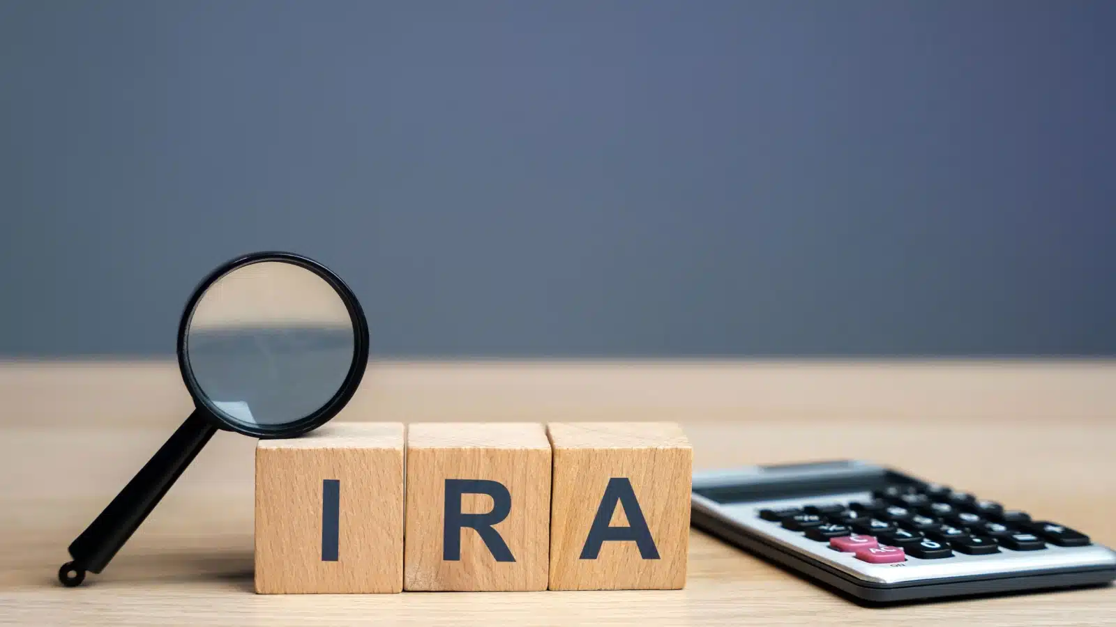 Wooden blocks spelling out IRA to represent individual retirement accounts.