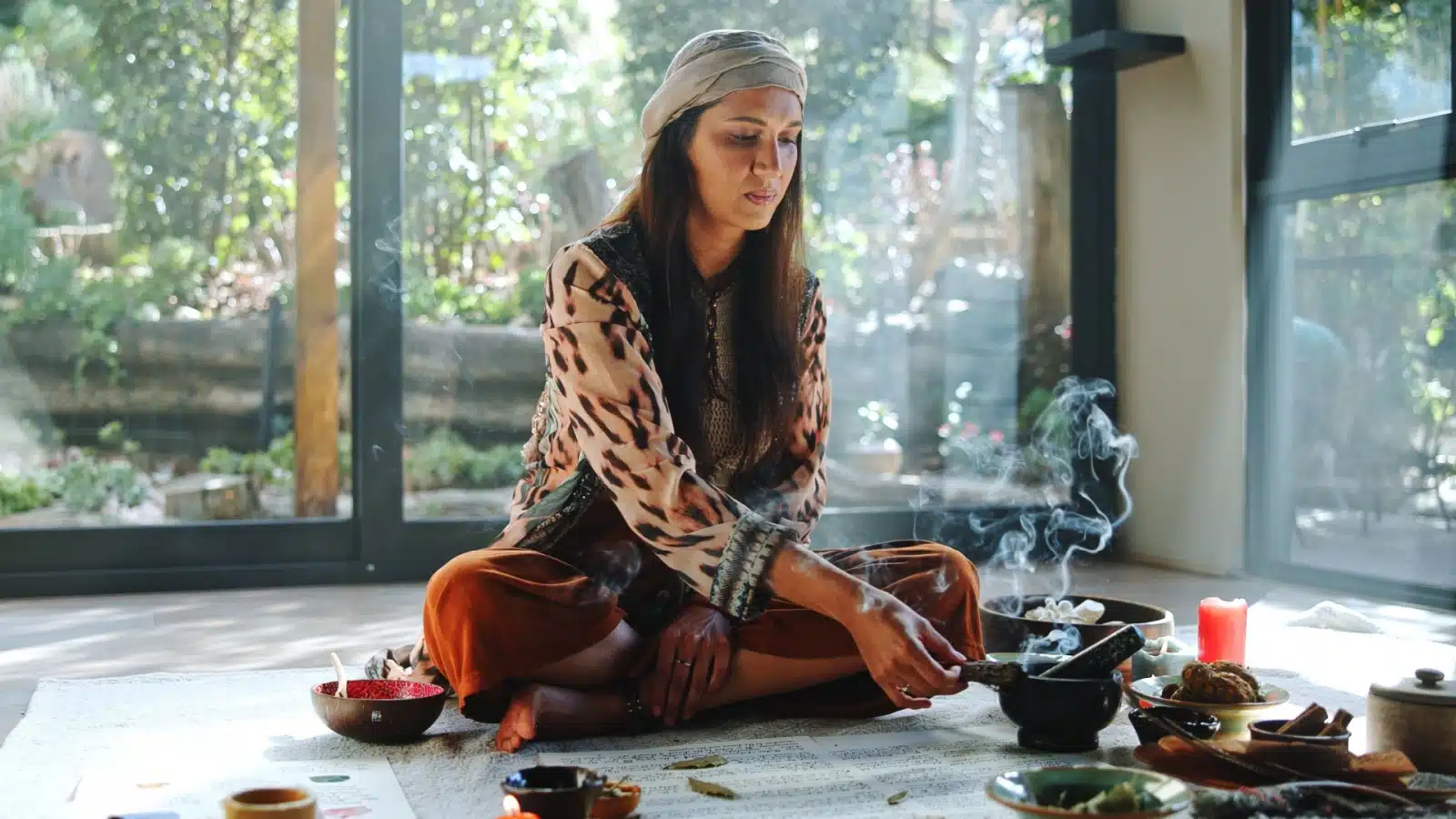 An eclectic witch does a magic ritual in her living room.