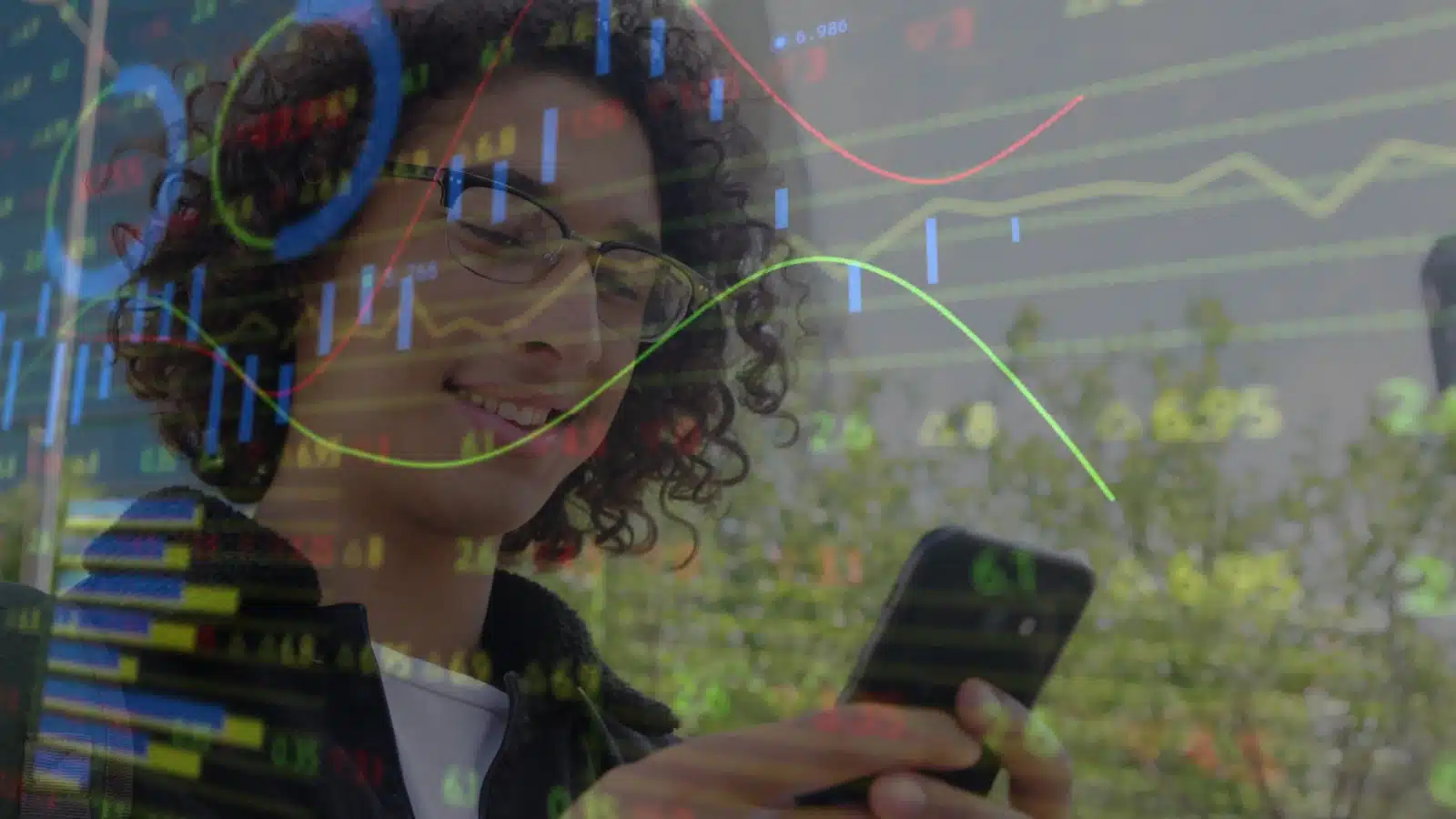 Concept art to help you start investing. A happy young man on his phone is overlayed with stock investment charts.