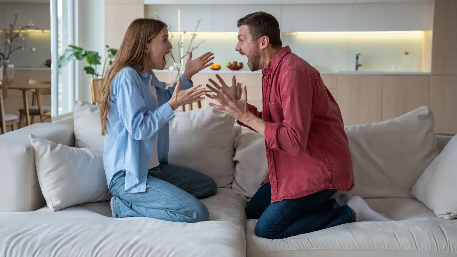 A couple fighting passionately on the couch represents toxic relationship signs