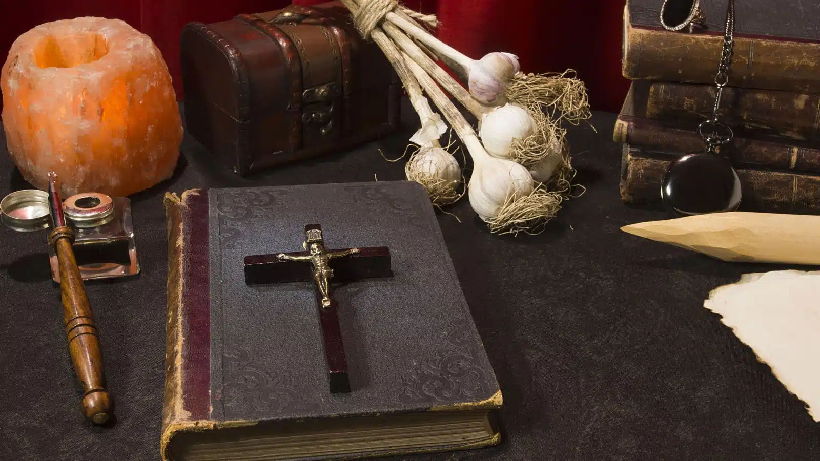 A vampire hunting kit featuring a crucifix, bible, and garlic.