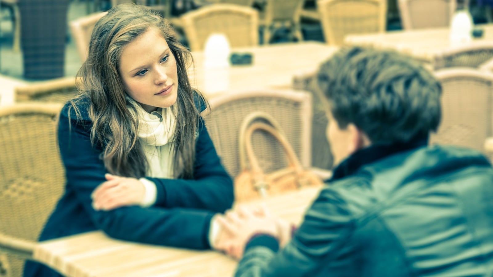 You can't fix him. A woman sits across the table from a man. They're in a deep conversation and she looks empathetic, like he's broken and she wants to fix him.