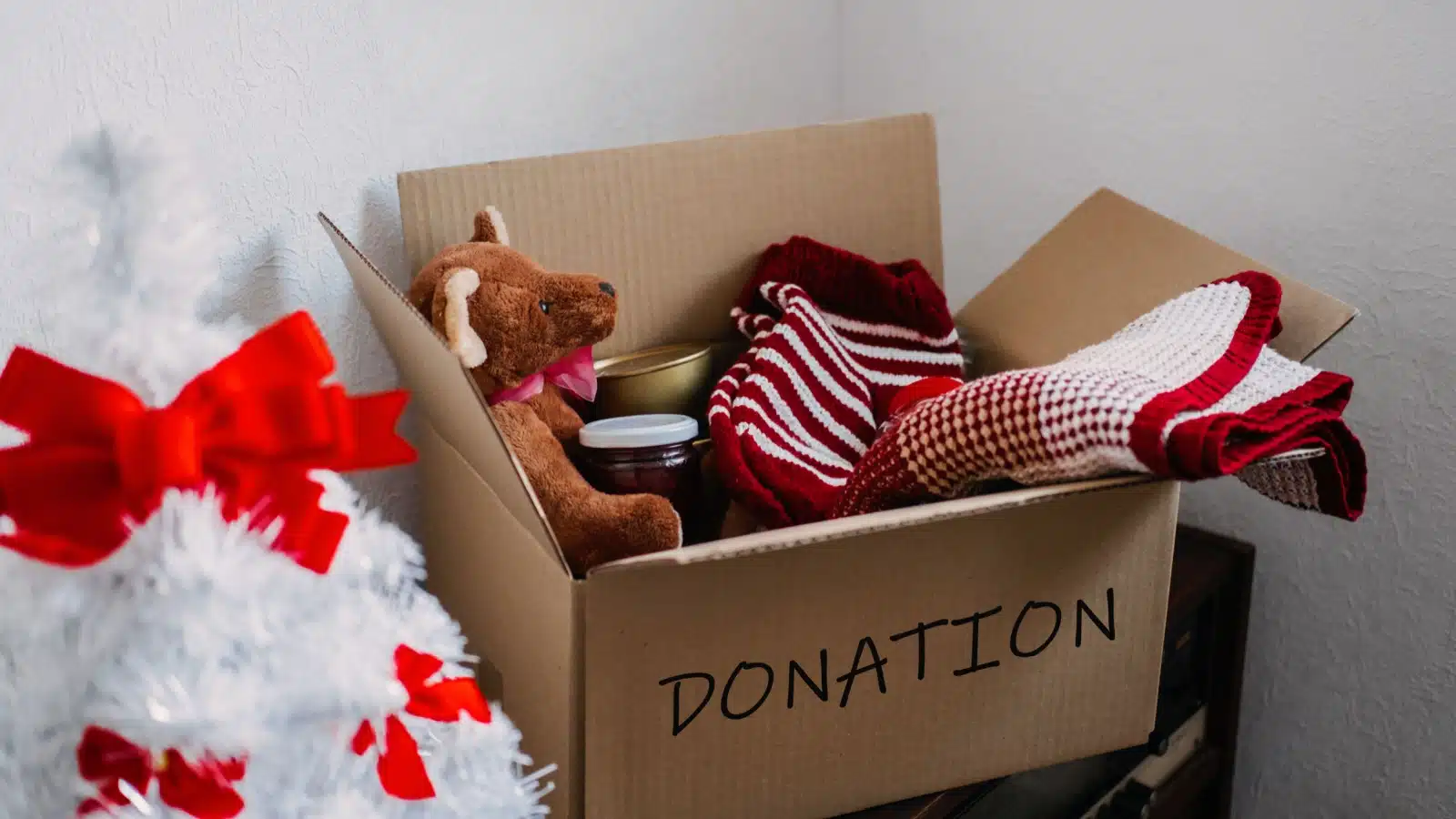 A charity donation box filled with Christmas items.