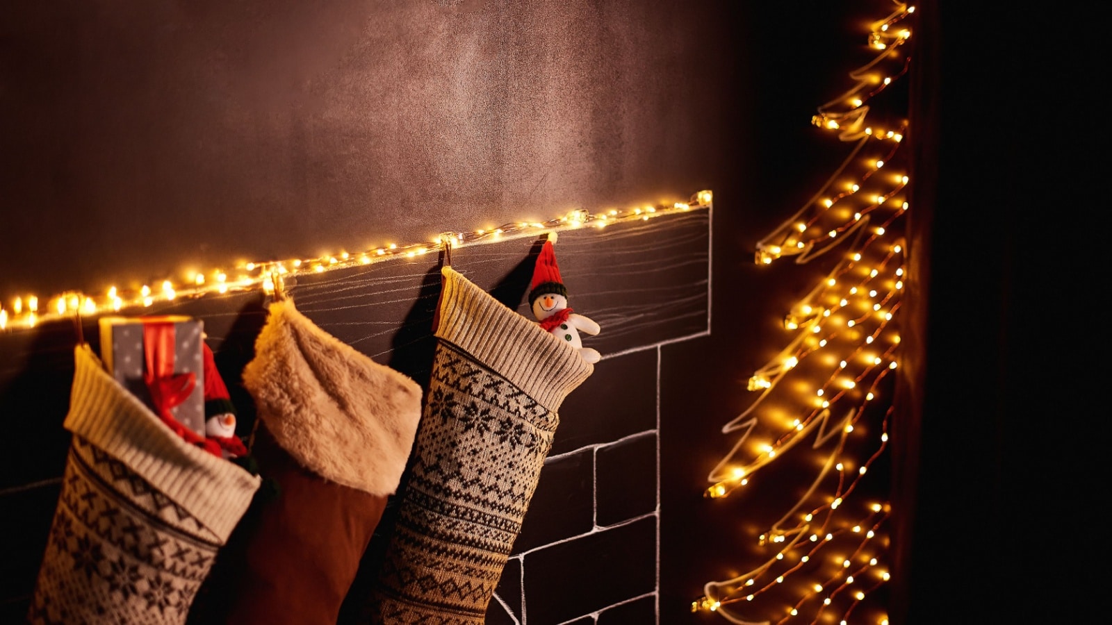 3 Christmas stockings hanging on the mantel. 