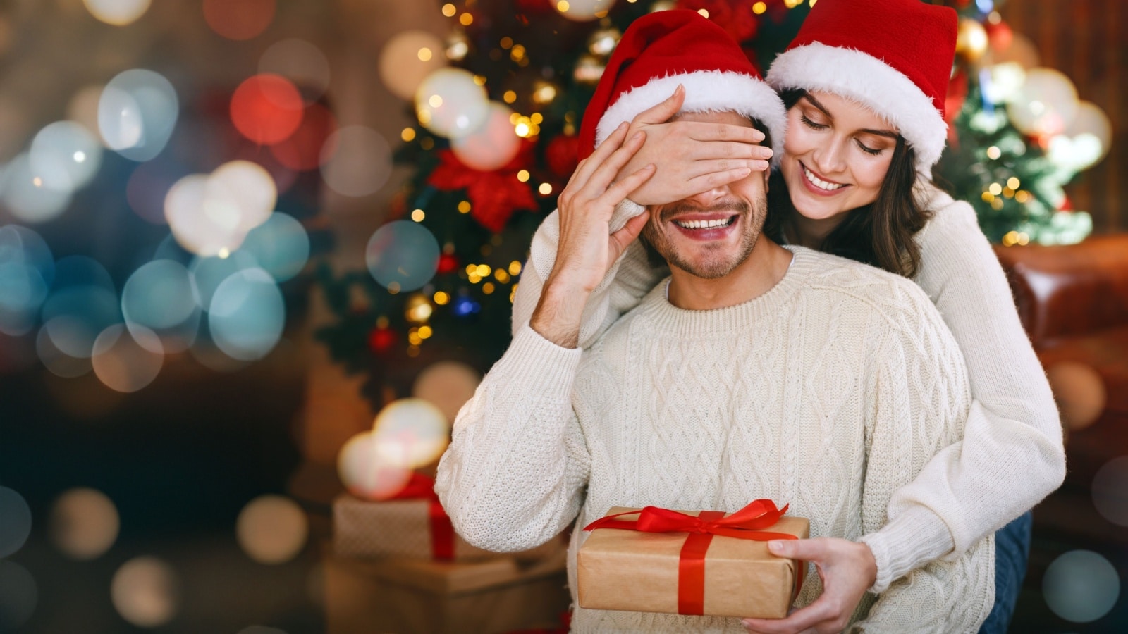 A woman giving her husband a Christmas gift to represent the five gift rule.