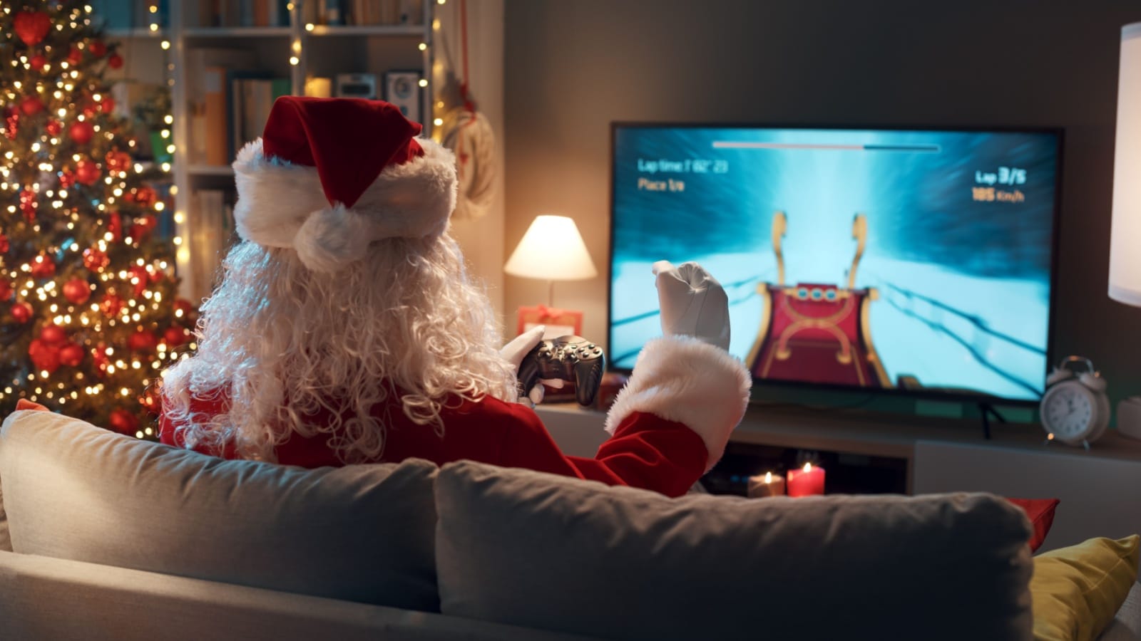 Santa on the couch playing a video game to represent the best gifts for gamers. 