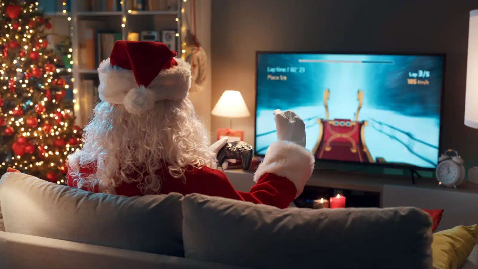 Santa on the couch playing a video game to represent the best gifts for gamers. 
