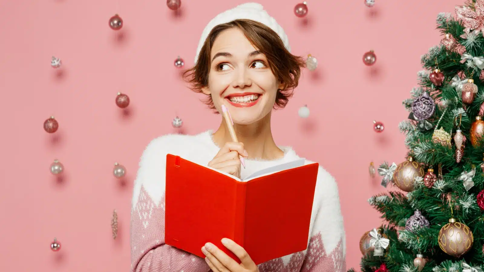 An excited woman thinks about what she wants for Christmas.