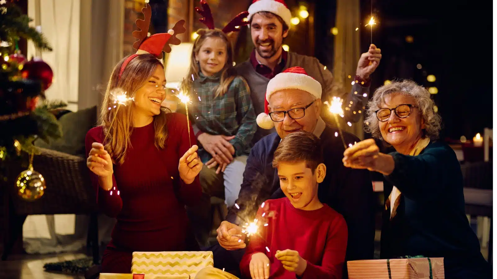An extended family featuring grandparents, parents, and children celebrates Christmas together.
