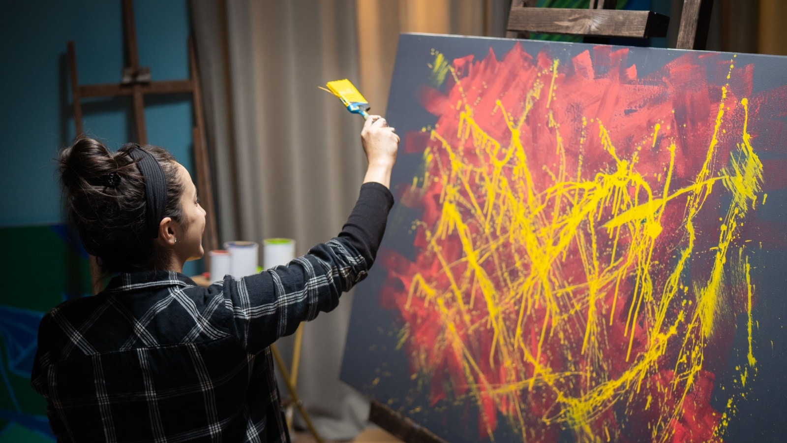 A woman experiments with abstract expressionism. 