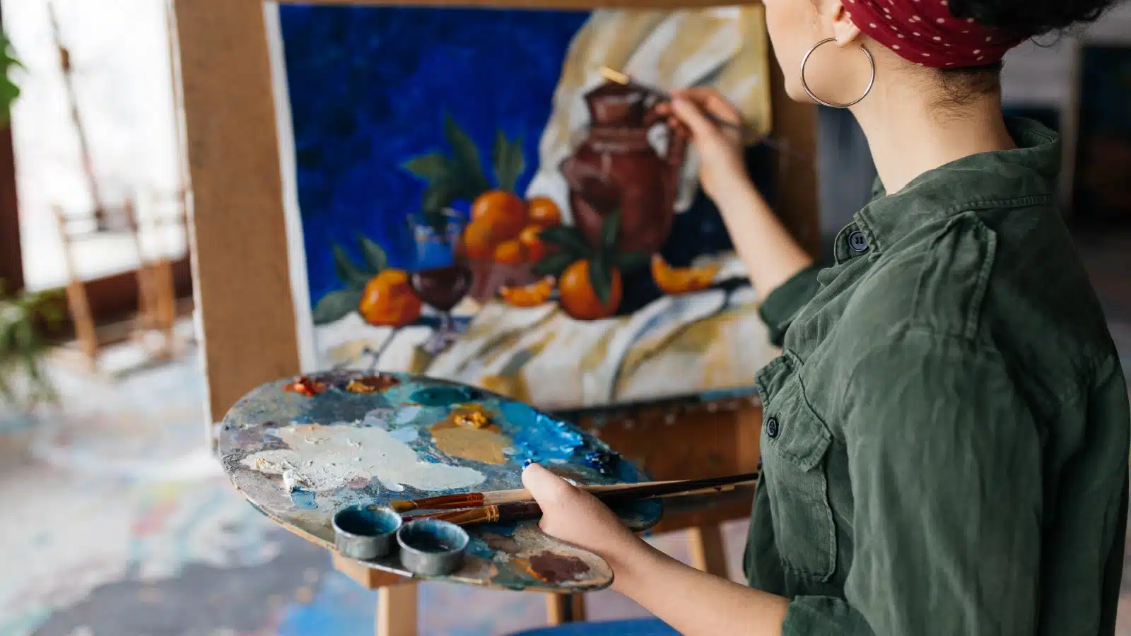 An artist paints a still life scene.