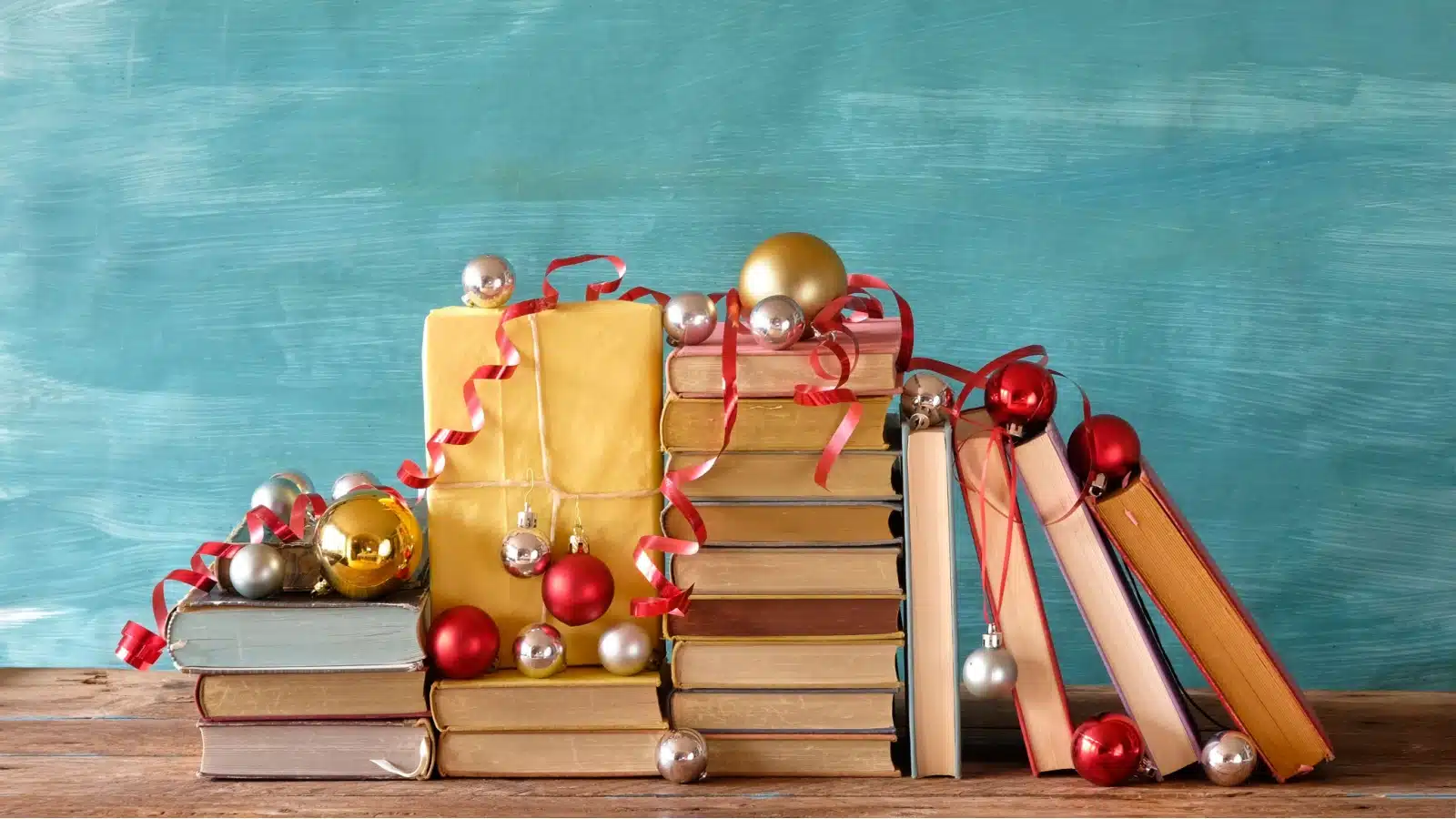 Books make great Christmas gift ideas! Here, books are wrapped and piled with presents.