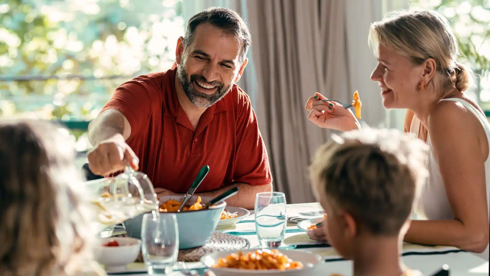 A happy family enjoys dinner together.