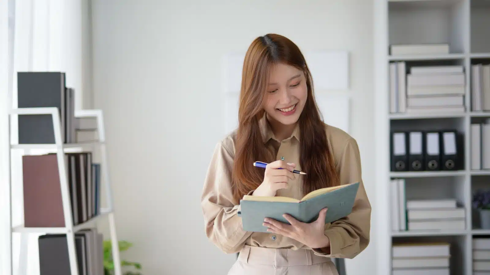 A woman uses a journal at work.