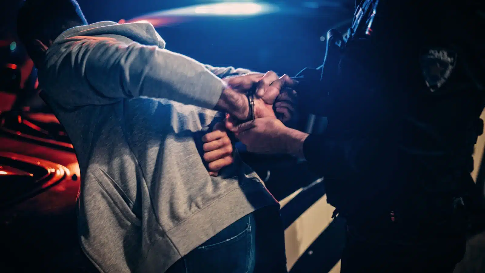 A police officer arrests a suspect.