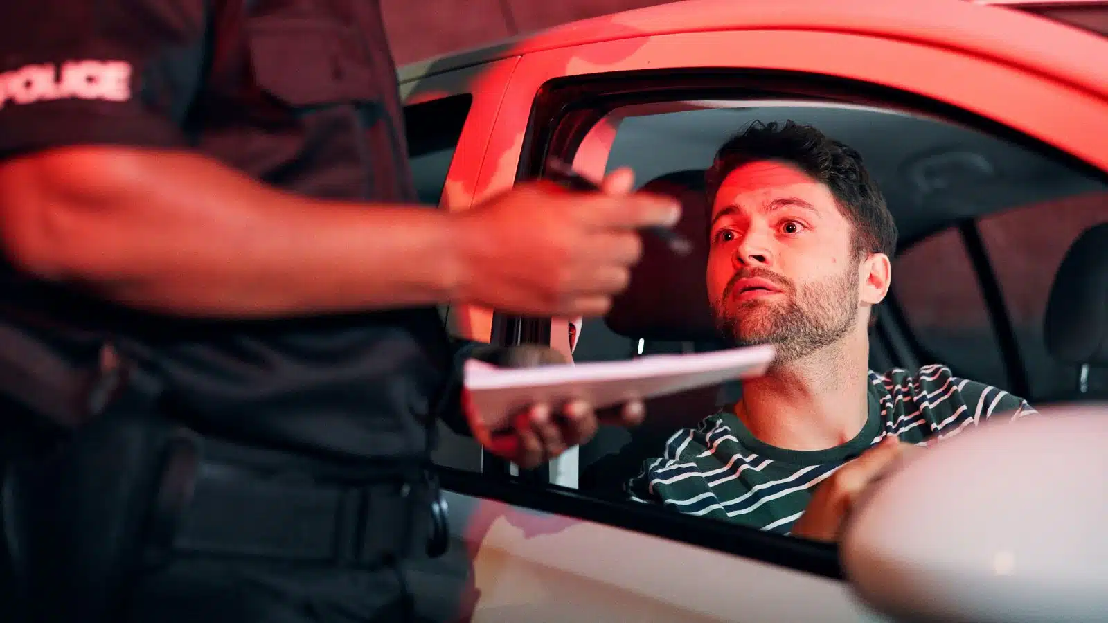A police officer talks to a man during a traffic stop.
