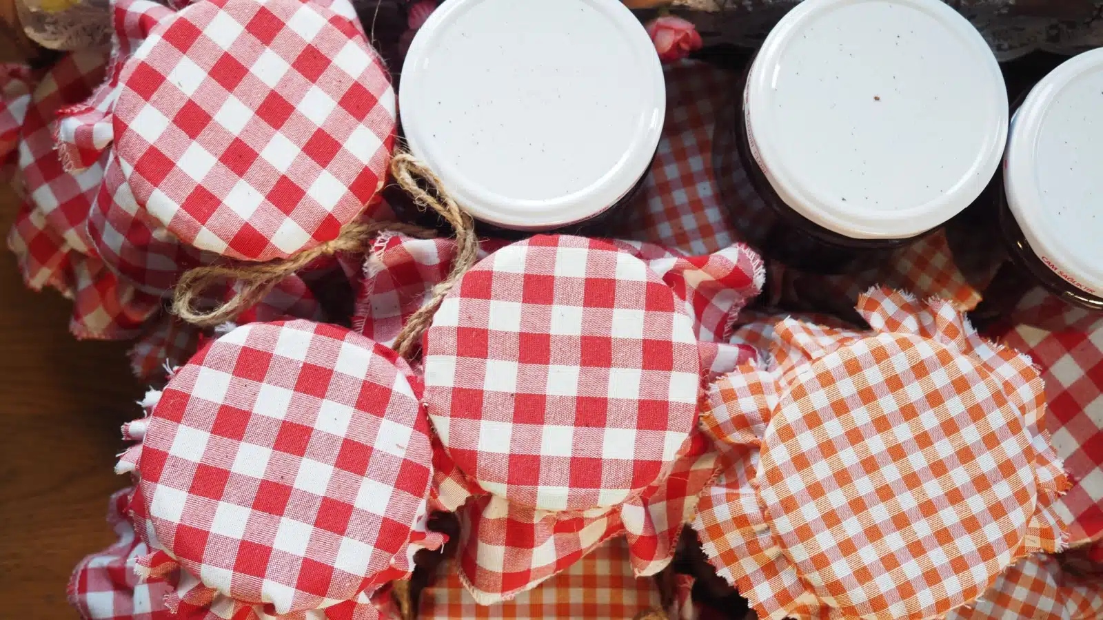 A stack of pretty homestead jars filled with preserves.