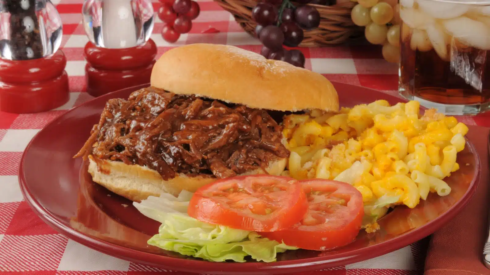 A pulled pork sandwich with mac & cheese.