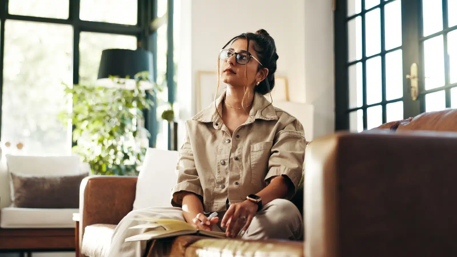 A woman thinks about what to write in her journal. 