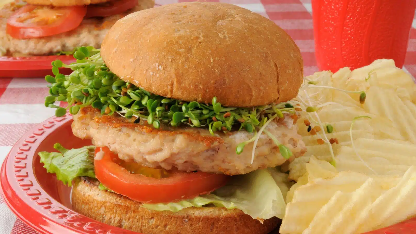 A turkey burger served with chips.