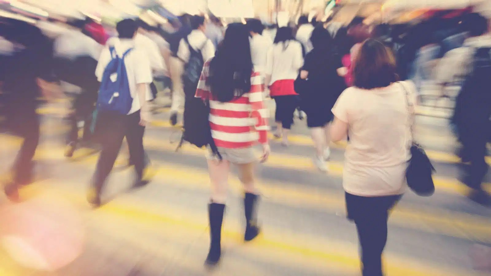 A blurred crowd of people walking.