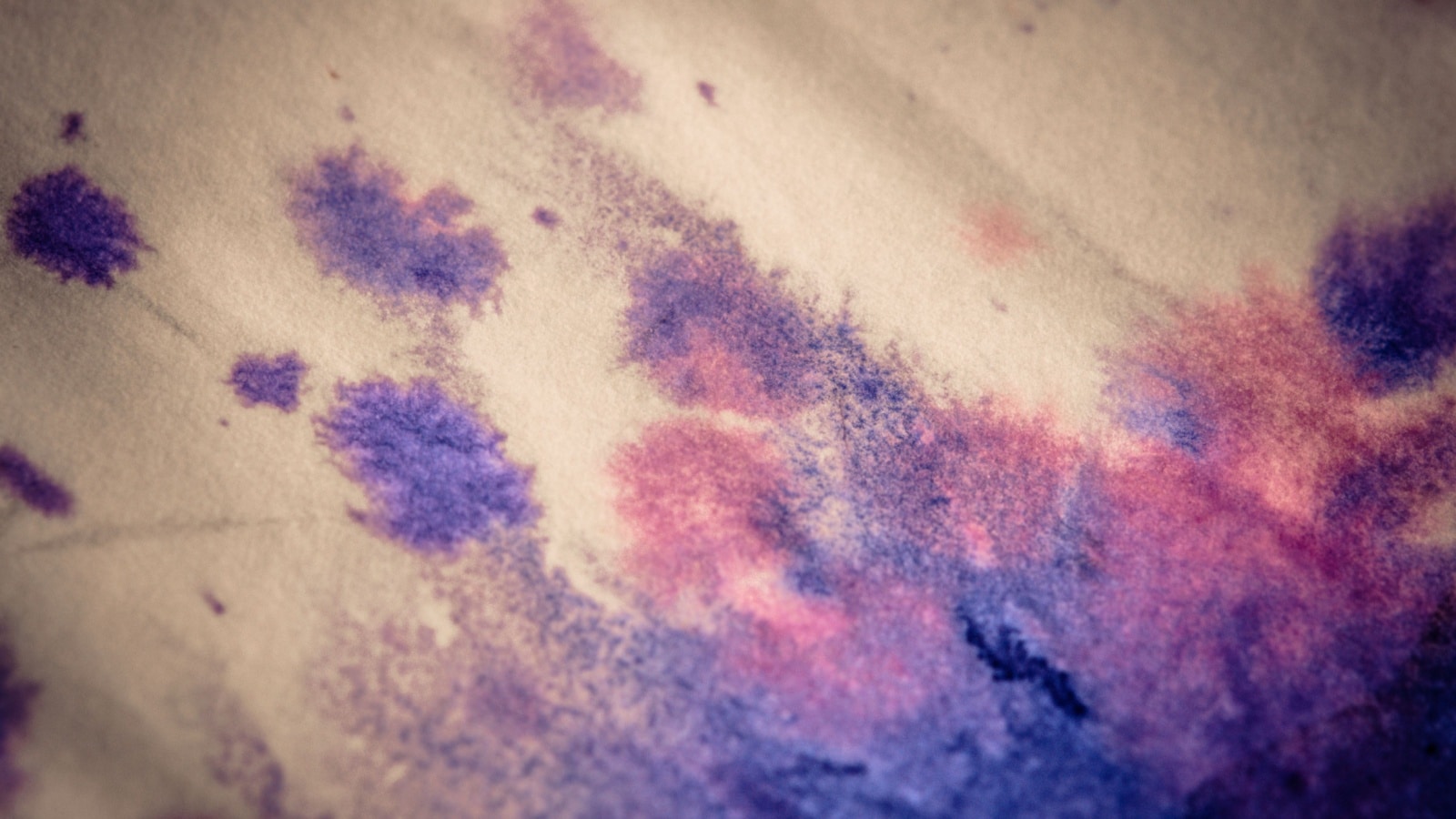 Close up of watercolor paper soaking up the spreading pigment. 