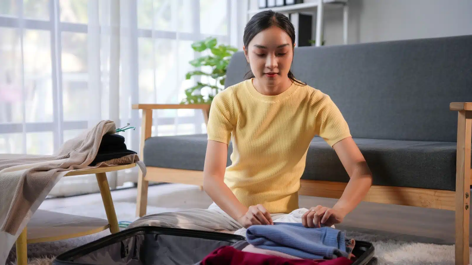 A woman packing her suitcase for a trip.