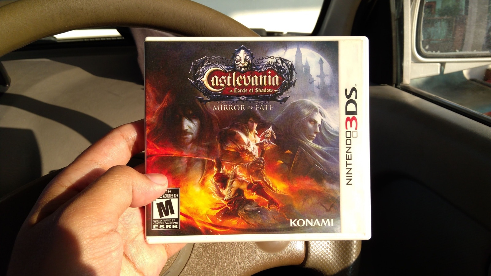 A person holds the game package for Castlevania Lord of Shadows, the 3ds version of the iconic game. 