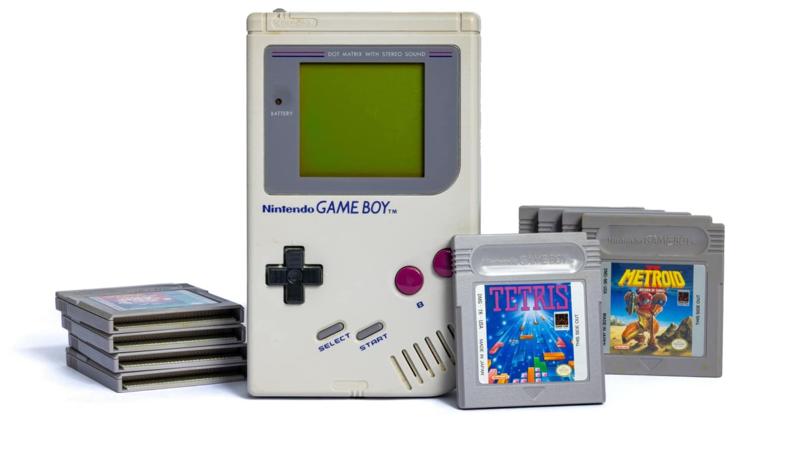 A vintage Nintendo Gameboy handheld system surrounded by Gameboy games, including Tetris. 