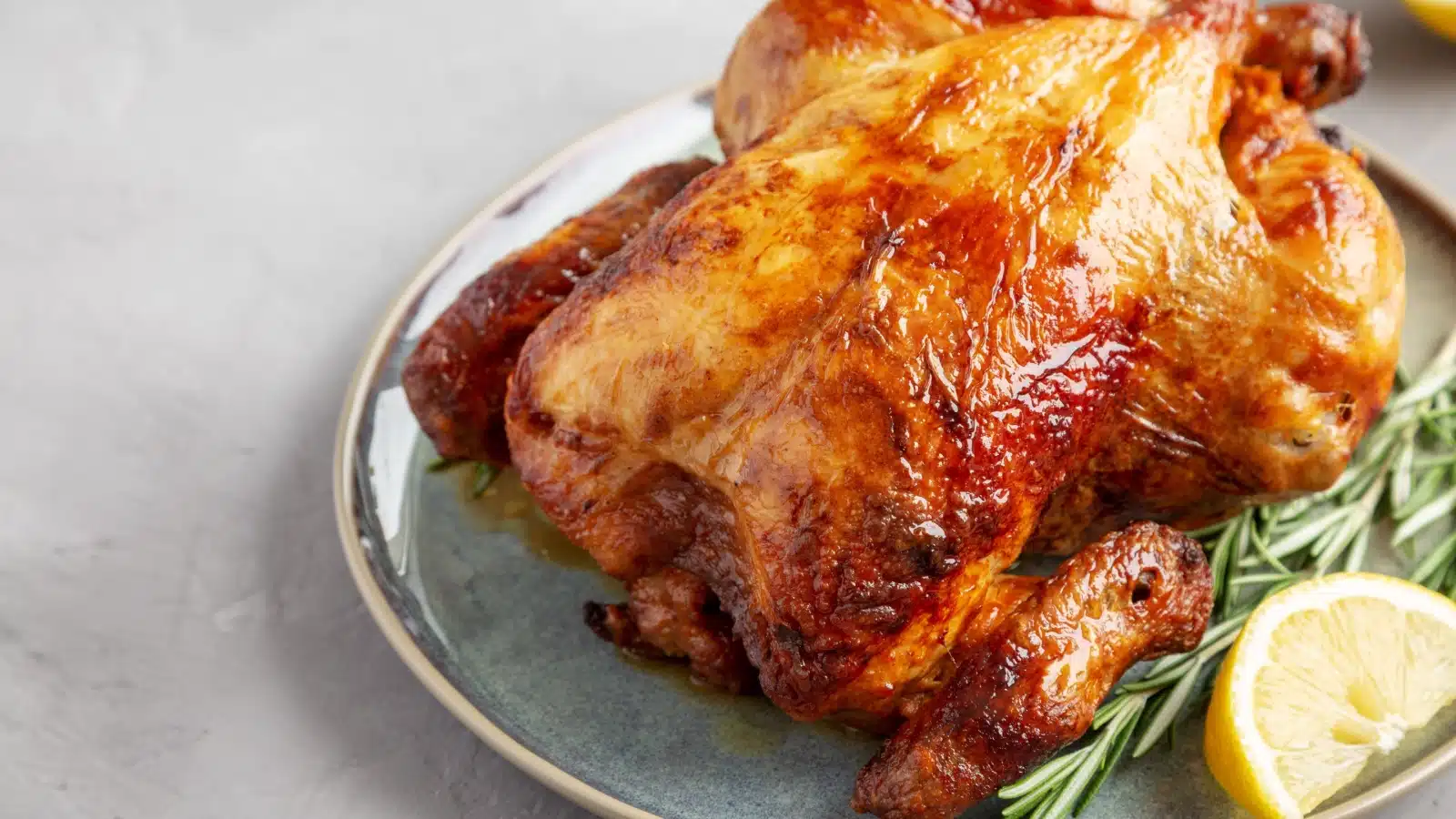 A rotisserie chicken on a plate.