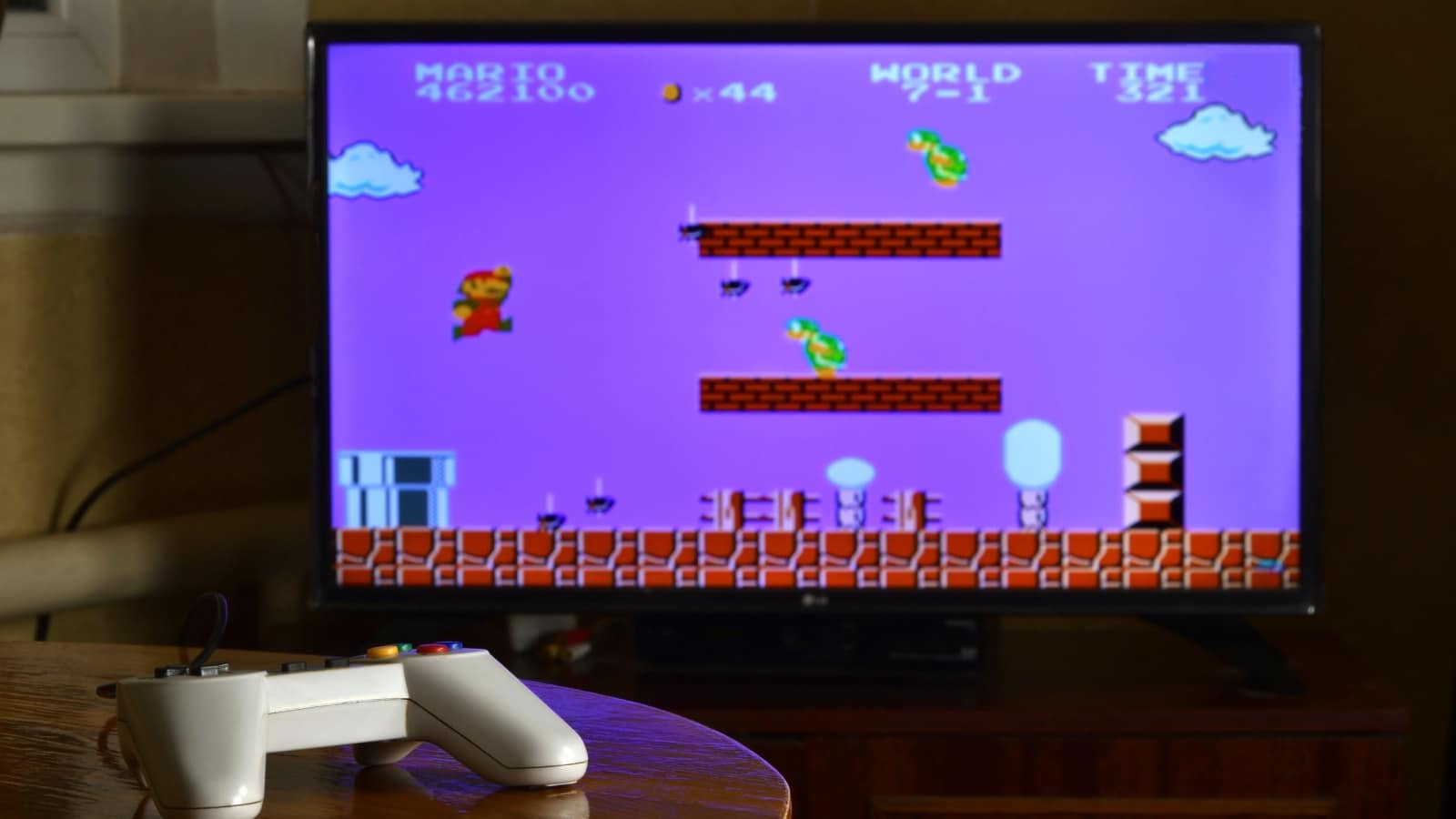 An old television screen showing a scene from the original Super Mario Brothers game from NES, one of the best old games. 