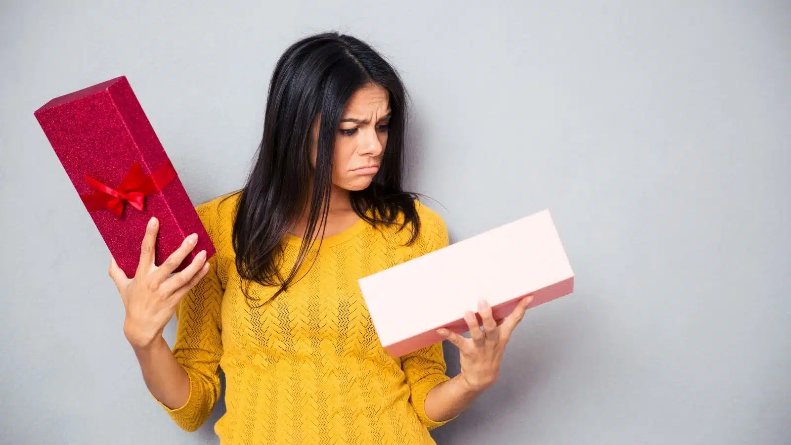 A woman looks sadly at a horrible gift she received.