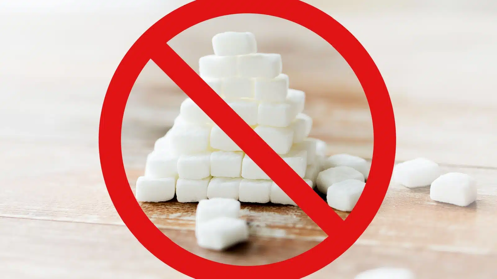 A pile of sugar with a giant red cross mark in front of it to represent no sugar.