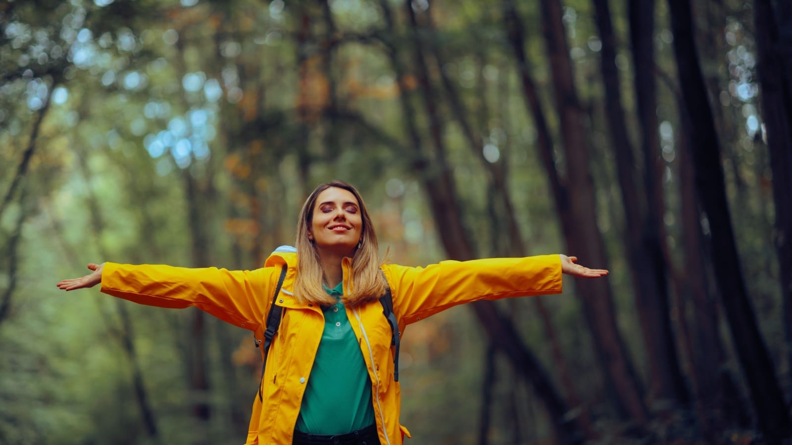 A happy woman enjoying nature to represent reasons to be happy.