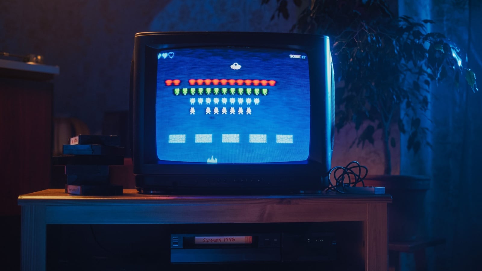 A retro 80s-style television showing a retro style video game. 
