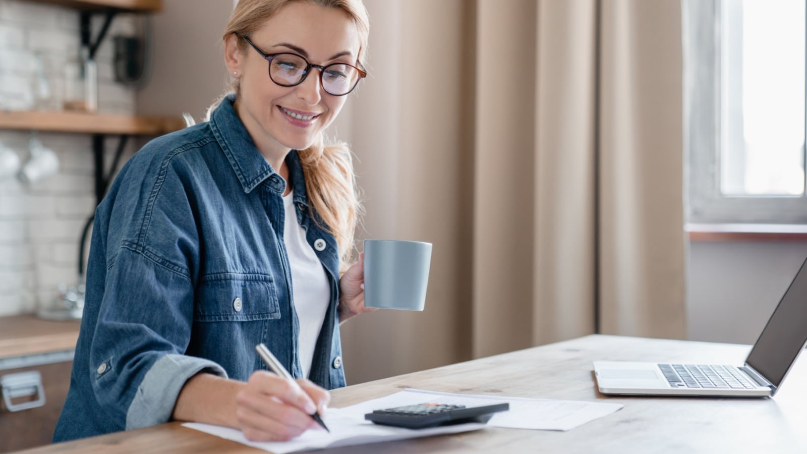 A woman works from home keeping books to represent side hustles that work.
