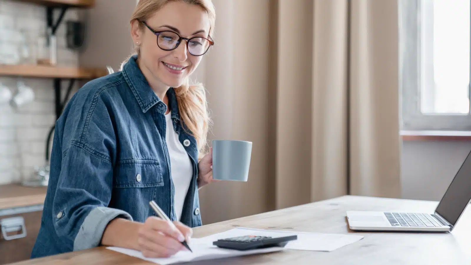 A woman works from home keeping books to represent side hustles that work.