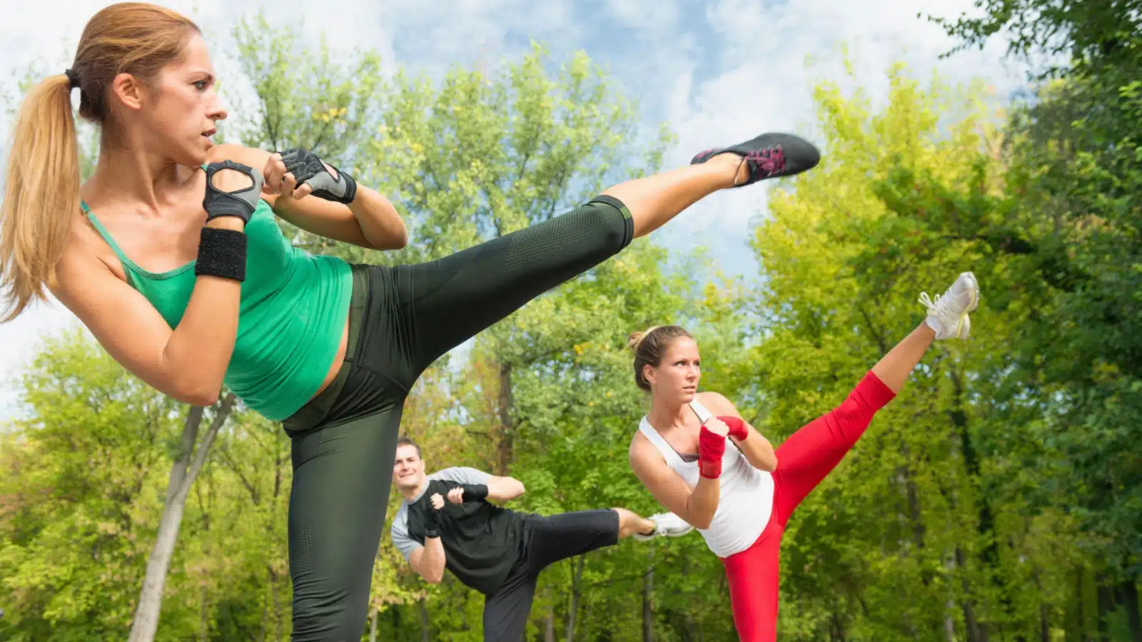 A group doing tae bo in a field. 