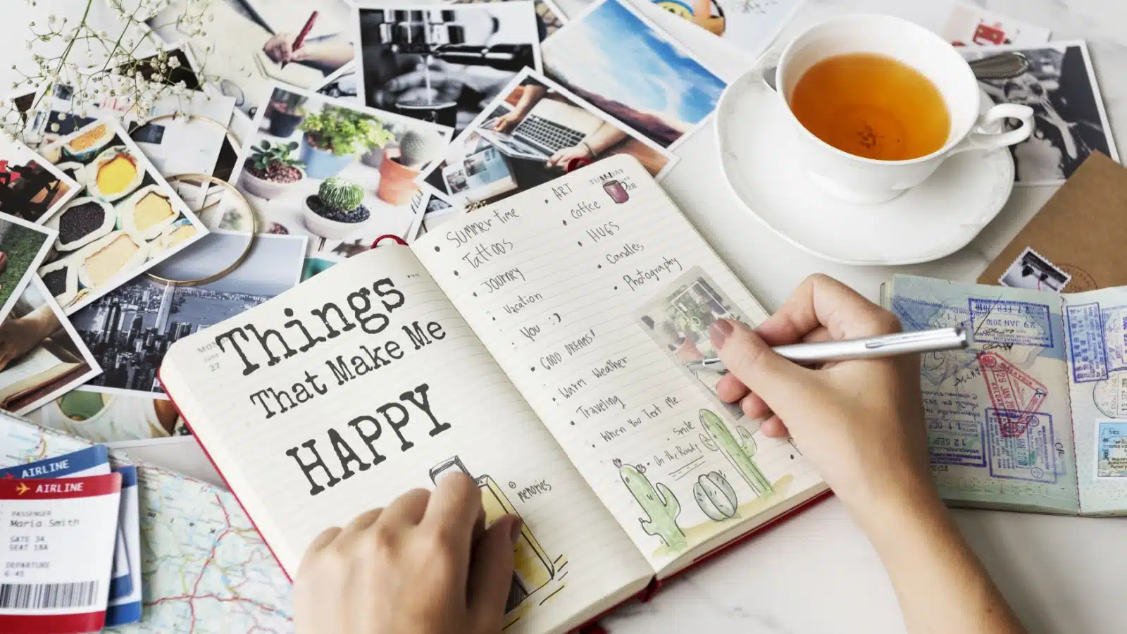 A woman writing a list of things that make her happy in her journal.