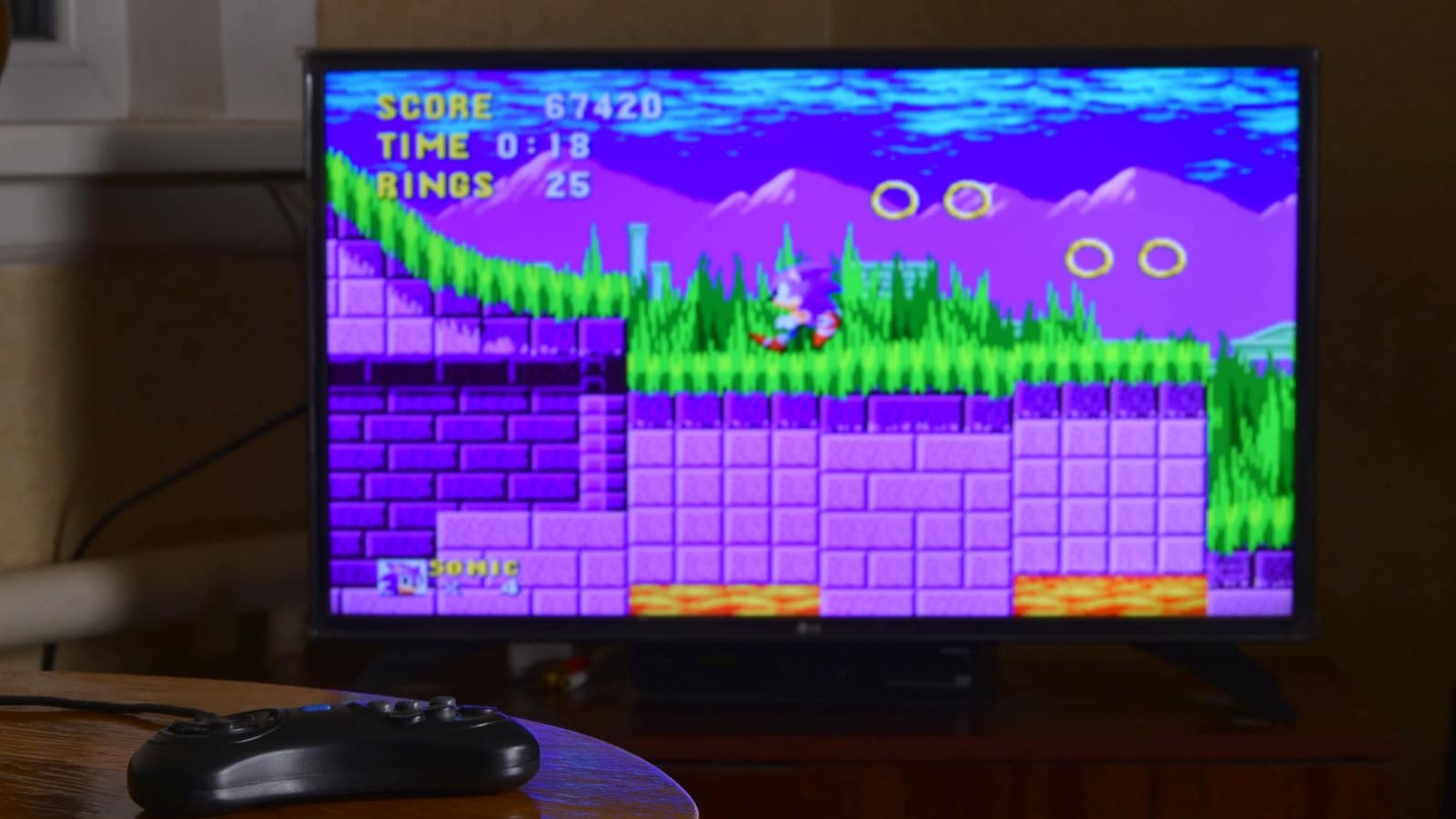 A vintage television showing a scene from an old Sonic the Hedgehog game. 