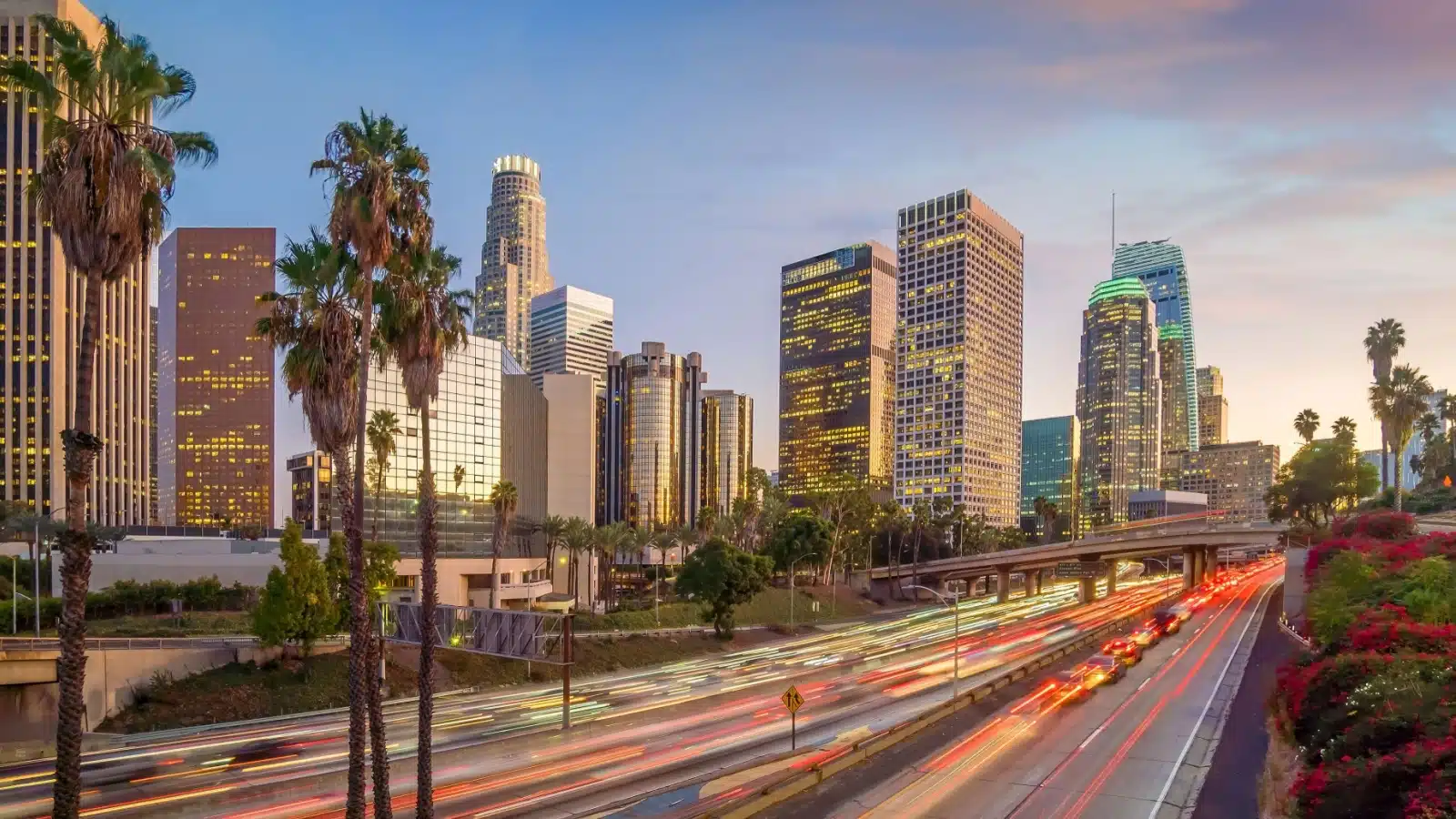 A time lapsed view of LA from a freeway around sunset.