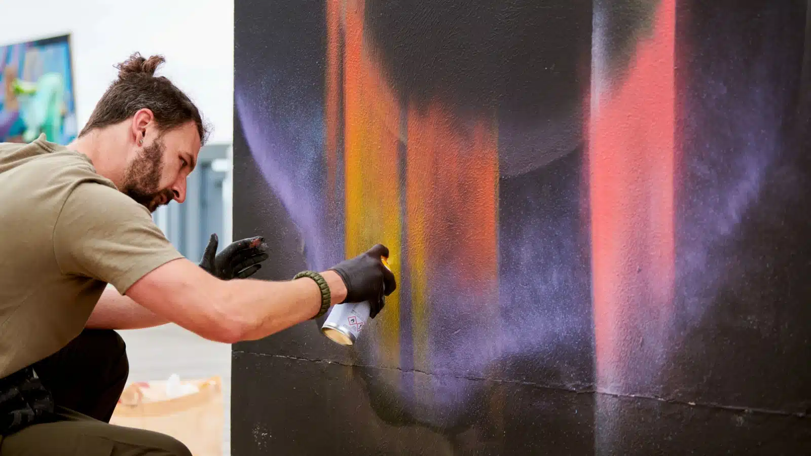 A man creates art with spray paint to represent the different media you can use while pursuing artistic hobbies.