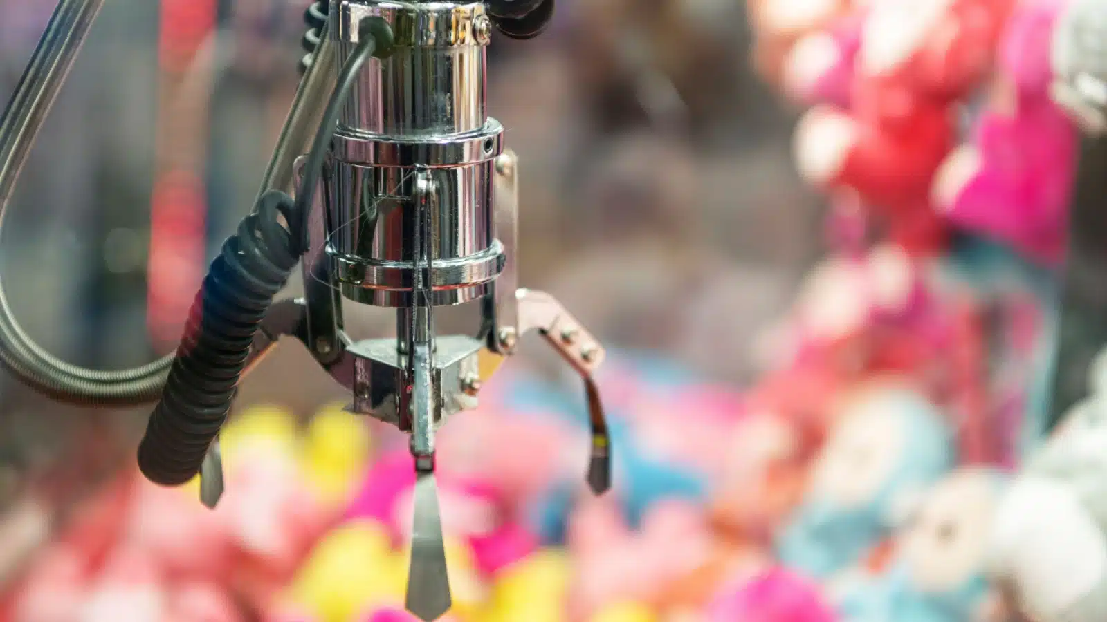 Close up of a claw machine at an arcade.