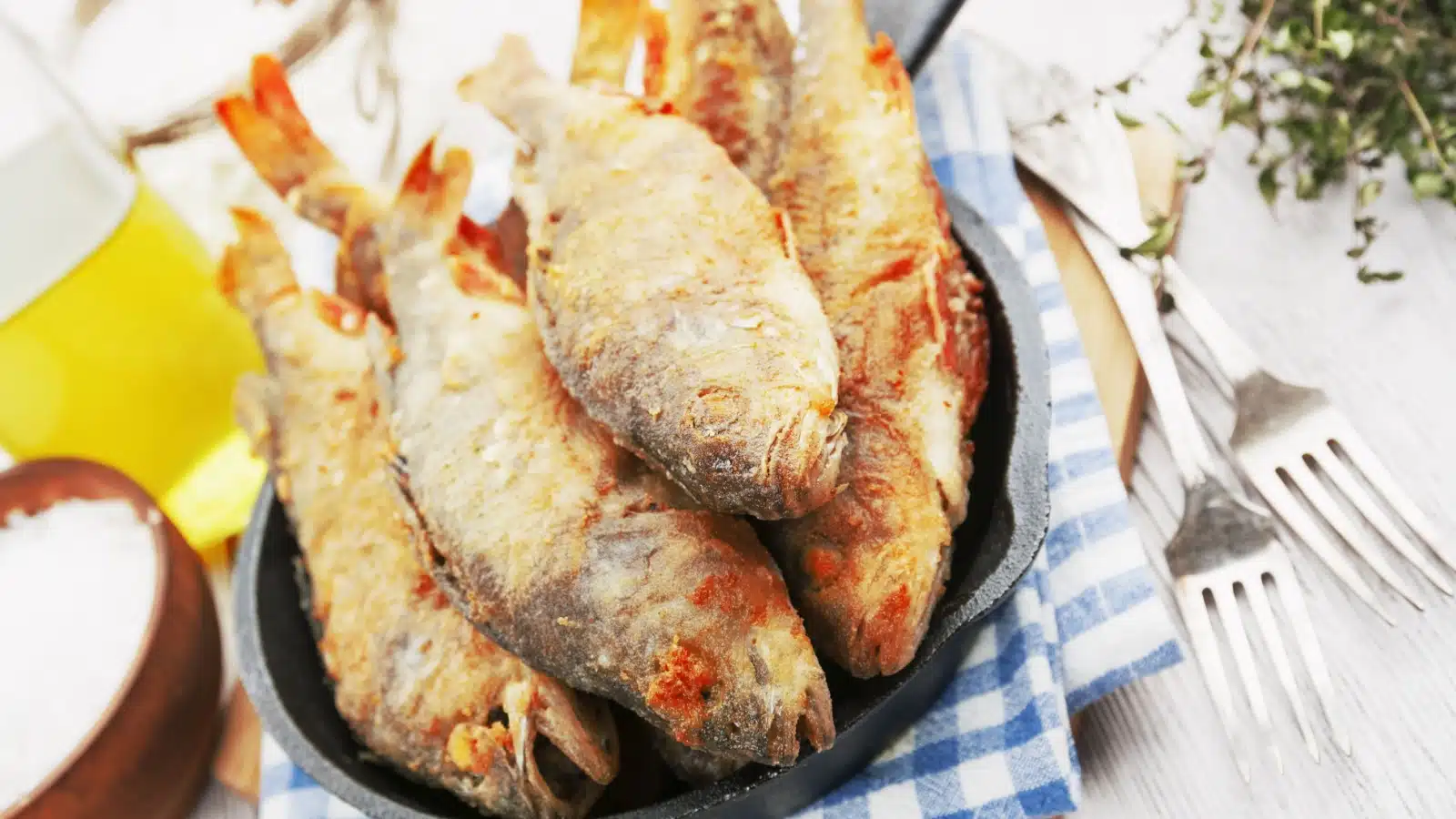 Deep fried whole fish in a frying pan.