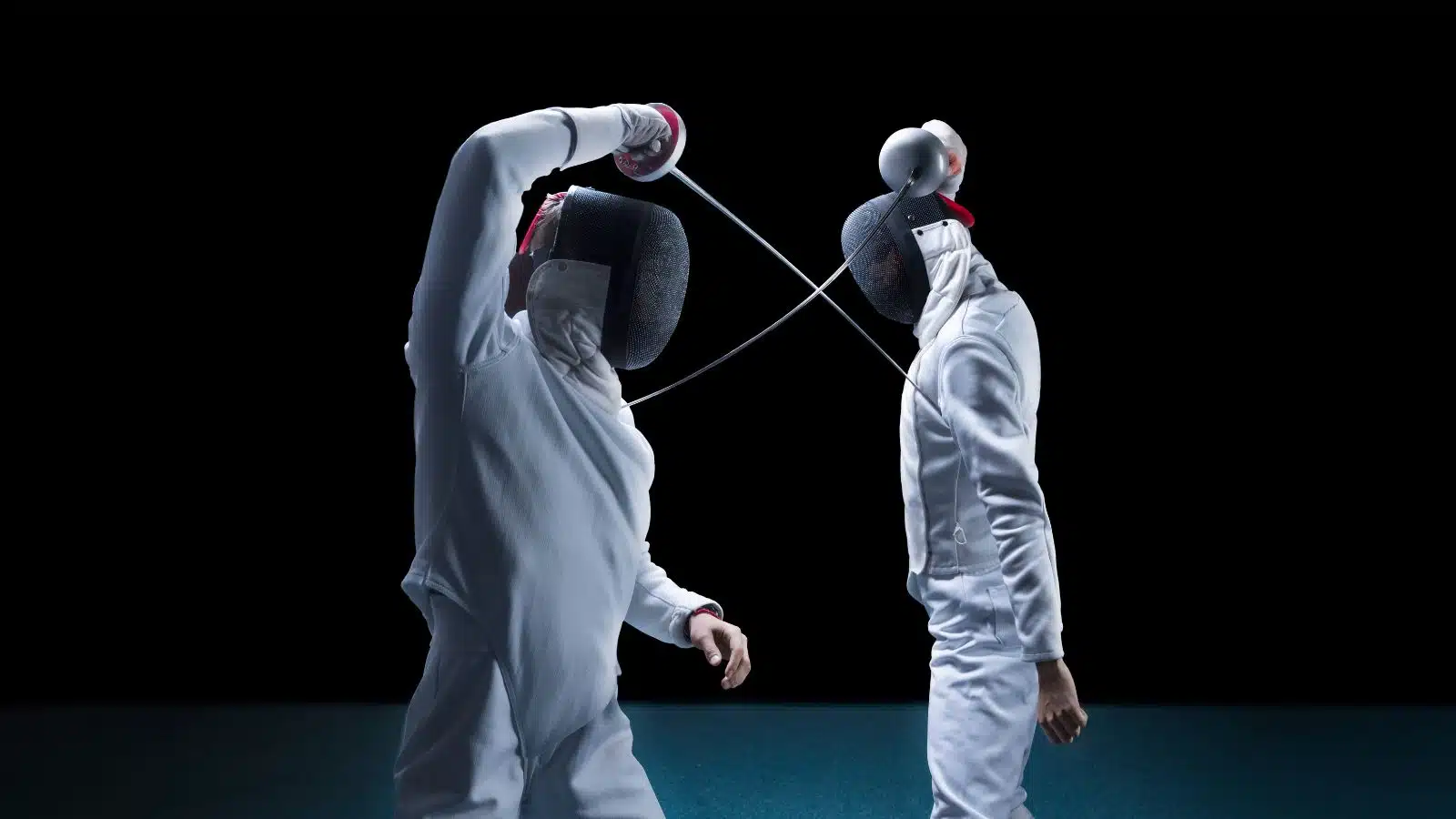 Competitors face off in a fencing match.